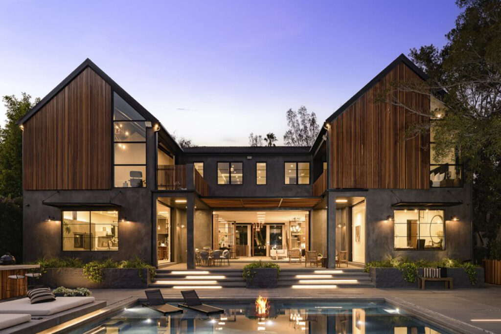 Barndominium-style luxury home with expansive windows, wood paneling, and open-concept living by DesignX Studios.