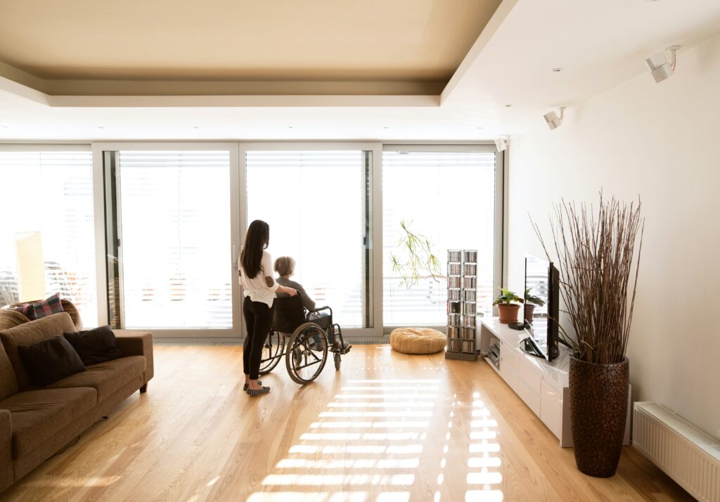 Designing for Aging in Place: A bright, accessible home interior with wide spaces accommodating a wheelchair user, promoting safety and independence.